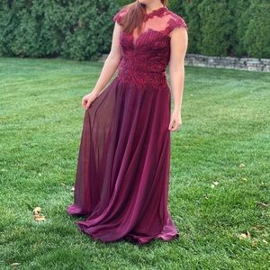 A beautiful burgundy floor length gown. MONTAGE by Mon Cheri